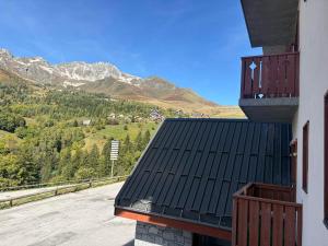 a balcony of a building with a view of a mountain at Appartement 2 chambres aux pieds des pistes, parking gratuit - FR-1-807-125 in Saint-François-Longchamp