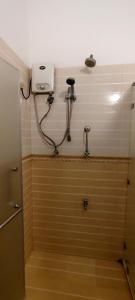 a shower in a bathroom with a hose on the wall at Roamers Ark Galle in Galle +45 photos