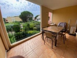 a room with a table and a balcony with a view at Appartement 3 pièces avec climatisation dans résidence avec piscines et tennis - FR-1-100-364 in Cavalaire-sur-Mer +6 photos