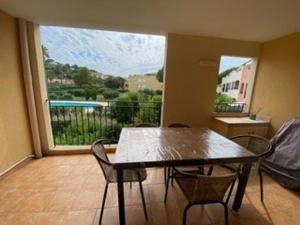 a dining room with a table and chairs and a large window at Appartement 3 pièces avec climatisation dans résidence avec piscines et tennis - FR-1-100-364 in Cavalaire-sur-Mer