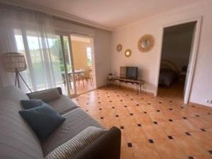 a living room with a couch and a wooden floor at Appartement 3 pièces avec climatisation dans résidence avec piscines et tennis - FR-1-100-364 in Cavalaire-sur-Mer
