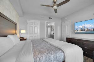 a bedroom with a large bed and a ceiling fan at Anderson Ocean Club #1611 in Myrtle Beach