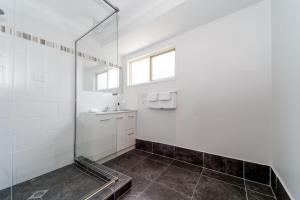 a bathroom with a shower and a sink at Scarness Spacious Home with Pool in Scarness