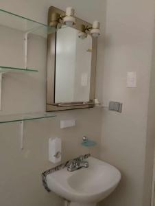 a bathroom with a sink and a mirror at Casa en Lambayeque in Lambayeque +10 photos
