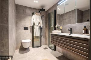 Un baño con lavabo, inodoro y ducha. en Brand New & High-End 3 Bedrooms 2 Bathrooms Central Apartment, en Bergen