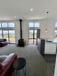 a living room with a couch and a stove at Flat White in Lake Tekapo +15 photos