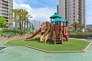 a playground with a slide in a park at Waikiki Banyan Ohana Suite in Honolulu