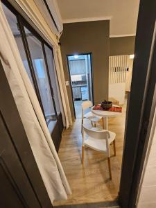 a room with a table and a chair and a table at Departamento Ejecutivo 10 m de la Catedral Tango 10 in San Fernando del Valle de Catamarca +8 photos