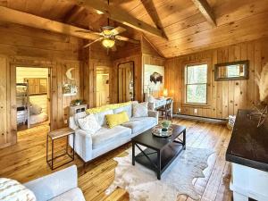 a living room with a couch and a table at 1930's Highlands Hideaway in Highlands
