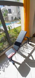 a treadmill sitting on the floor next to a window at Affordable Luxury Apartment in Nouaseur