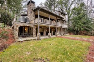 a large stone house with a wrap around porch at Floralia in Highlands