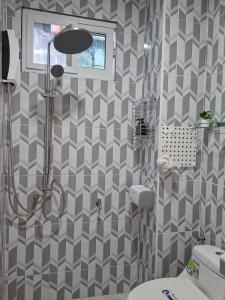 a bathroom with a shower and a toilet at Suwita House in Nai Yang Beach