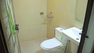 a bathroom with a shower and a toilet and a sink at Premium Villas and Appartments thekady in Thekkady