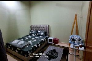 a small bedroom with a bed and a crib at Homestay Kuala Berang Bonda Full Aircond Wifi & Netflix in Kuala Berang