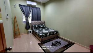 a living room with a chair and a window at Homestay Kuala Berang Bonda Full Aircond Wifi & Netflix in Kuala Berang