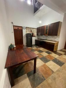 a large kitchen with a wooden table in a room at Larala Villa with private pool in Mawadawila