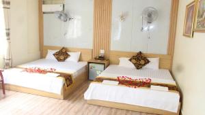 Ένα ή περισσότερα κρεβάτια σε δωμάτιο στο Văn Phượng Hostel