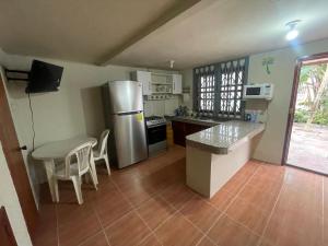 a kitchen with a stainless steel refrigerator and a table at Casa del Capi in Playas