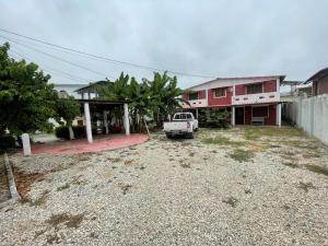 a parking lot with a truck parked in front of a building at Casa del Capi in Playas