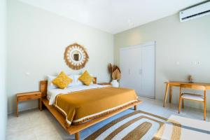 a bedroom with a bed and a table and a desk at Aquene 2 BR Private Pool Villa ZN277 in Pererenan