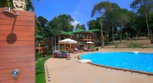 a large swimming pool in front of a house at The Green Hotel in Ko Lipe