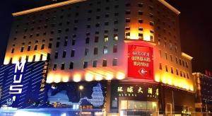 a building with a red tower in front of it at Changchun Global Hotel in Changchun