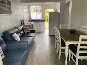 a living room with a couch and a table and a kitchen at Leisure Tourist Park in Port Macquarie +5 photos