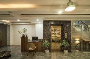 an office lobby with a desk and a staircase at The Passion Hotel Airport in Ho Chi Minh City