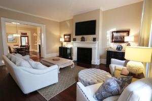a living room with white furniture and a fireplace at Oglethorpe Manor Main House in Savannah