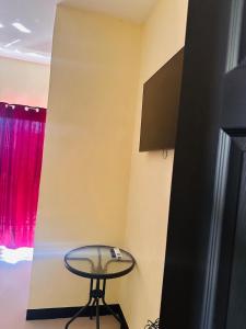 a table and a stool in a room with a window at Casa de Mama Francis Chiquimula in Chiquimula