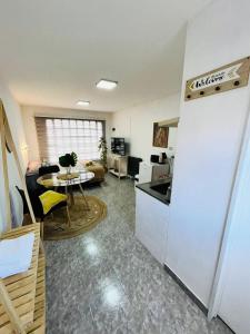 a kitchen and living room with a refrigerator and a table at Encantador monoambiente con parque in Río Gallegos