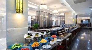a buffet line with many plates of food at E-Cheng Hotel Xiaogan Hanchuan Renming Road in Xiaogan