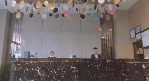 two men sitting at a counter in a room at Gya Hotel Yangzhou Economic Development Zone Yangzijiang Nan Road Gaomin Temple in Yangzhou
