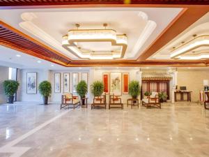 a lobby of a hotel with chairs and tables at GreenTree Eastern Hotel Linyi Linshu County Aegean Sea in Linyi