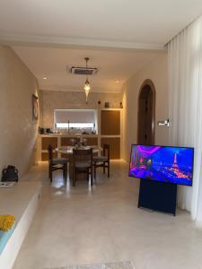 a living room with a large flat screen tv at Paradise Vine in Barka