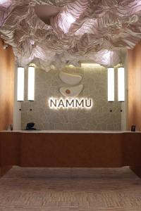a restaurant with a counter with a sign that reads namini at Nammu Spa and Wellness in Dubun