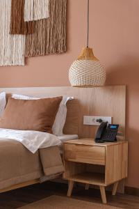 a bedroom with a bed and a table with a telephone at Nammu Spa and Wellness in Dubun
