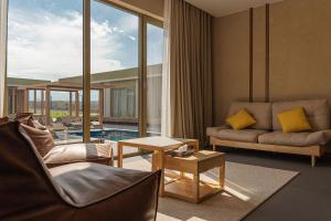 a living room with a couch and a table at Nammu Spa and Wellness in Dubun +2 photos