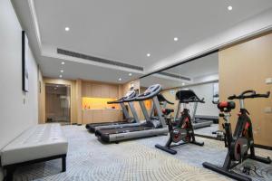a gym with several exercise bikes in a room at Echeng Hotel Enshi Minzu Road in Enshi