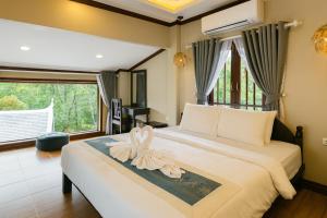 Postel nebo postele na pokoji v ubytování Villa Khili Phousi