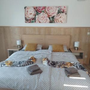 a bedroom with a bed with two pillows on it at Sobe Nobiles in Draganići