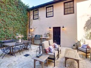 a patio with tables and chairs and a building at Elsewhere on Madison Square Manor in Savannah
