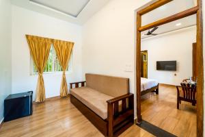 a living room with a couch and a bed at Samba Castle by Starling in Gokarna