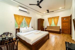 a bedroom with a bed and a table and a couch at Samba Castle by Starling in Gokarna +40 photos
