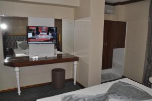 a hotel room with a television and a bed at Grand Sera Hotel in Ankara