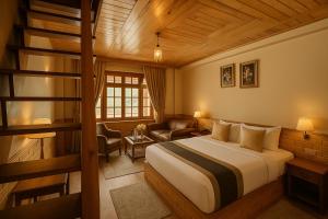 a hotel room with a bed and a staircase at Snow Clad Riverview Hotel & Resort, Manali in Manāli