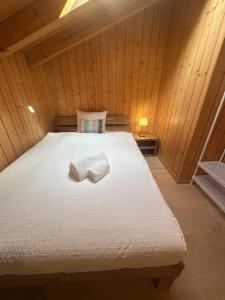 a bedroom with a bed with two towels on it at Villa Eiger Close to Grindelwald in Lütschental