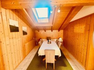a dining room with a table and a skylight at Villa Eiger Close to Grindelwald in Lütschental