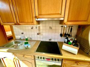 a kitchen with a sink and a counter top at Villa Eiger Close to Grindelwald in Lütschental +15 photos