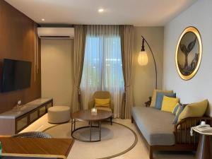 a living room with a couch and a table at Putri Duyung Ancol in Jakarta